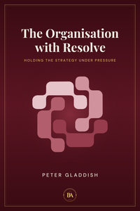 Cover of The Organisation with Resolve by Peter Gladdish. The same interlocking RESOLVE mark and gold rule again, in pale pink on deep burgundy, the third colourway in the series.